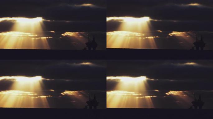 日落时北海海上平台上的石油钻塔