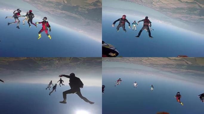 跳伞运动员从直升机上跳下来，进行空中杂技表演