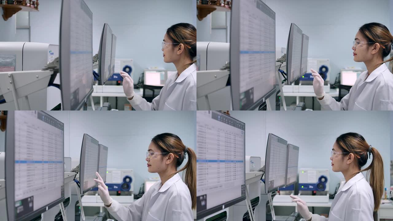 科学家使用计算机进行数据验证并使用触摸屏在操作中使用现代技术。4k分辨率慢动作。