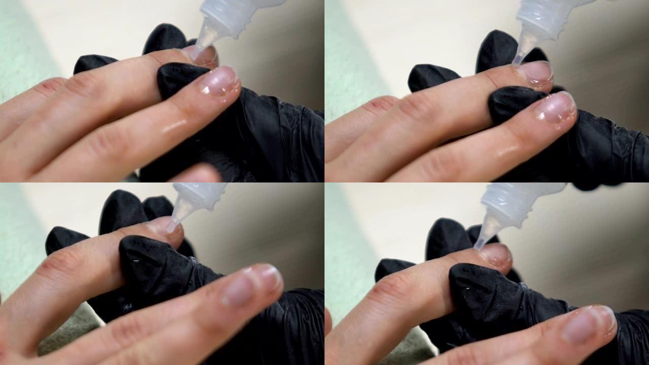 美容院工作人员在女性手指上应用角质层去除剂，修指甲