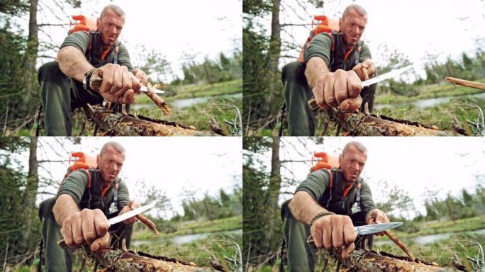 男性野外生存专家用他的刀在野外磨一根棍子的末端