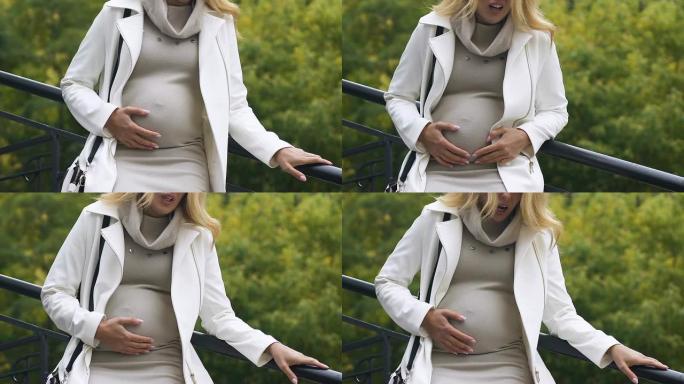 大肚子的年轻女士肚子疼得厉害，有提前分娩的风险