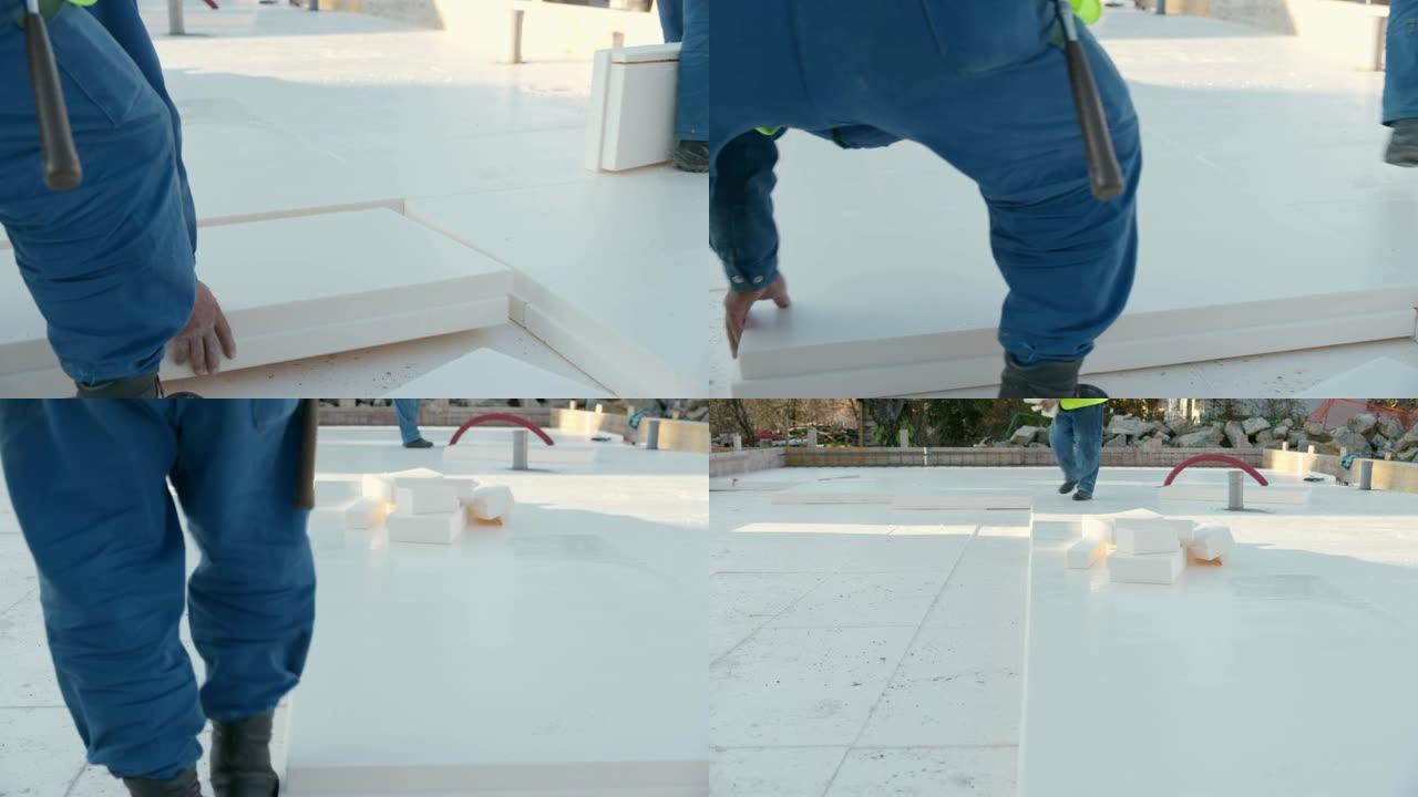 建筑工人将保温板放置在地基上