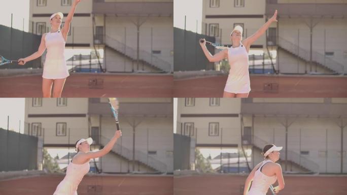 网球发球-女子网球运动员打球。夏天在外面打网球。适合女运动员练习。健康积极的运动生活方式。