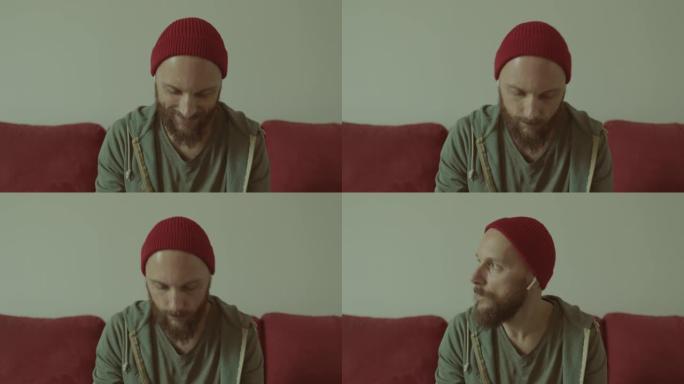 视频肖像: 留着胡须的男人在家听音乐