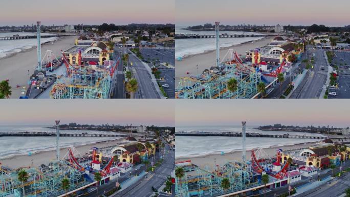 日出时在圣克鲁斯海滩上的封闭游乐设施和小海浪-无人机拍摄
