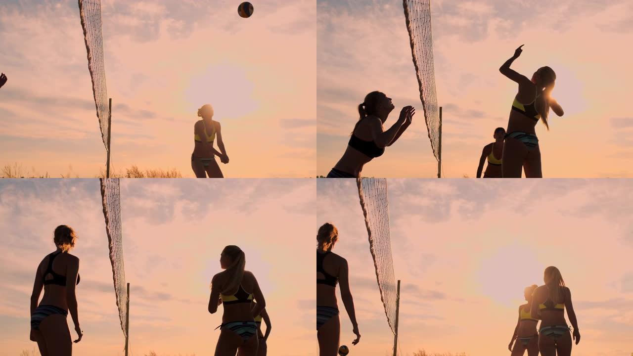 一群年轻女孩在日落或日出时打沙滩排球。