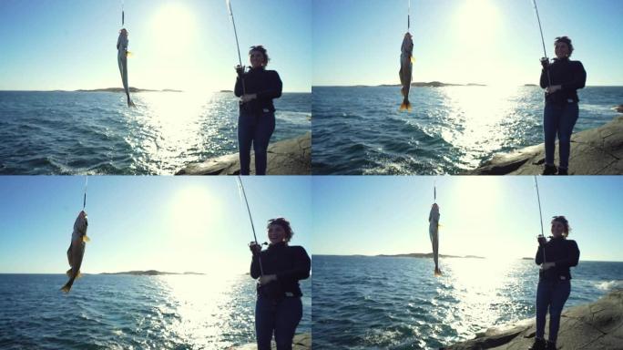 女人用钓竿在海里钓鱼，抓鳕鱼