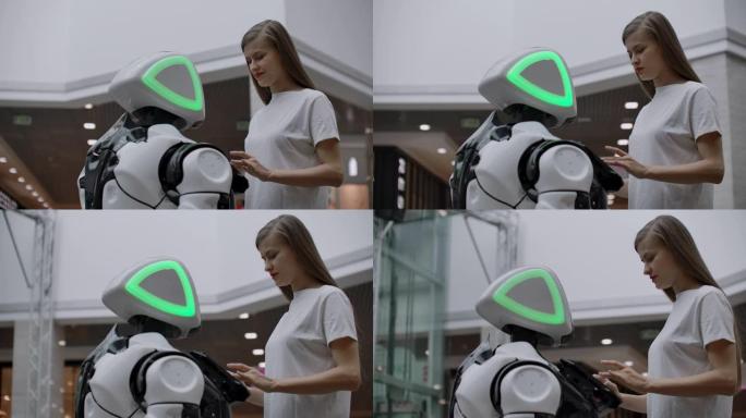 一位女程序员测试机器人与用户互动的能力。在办公室里使用机器人助手。机器人给女孩帮助。