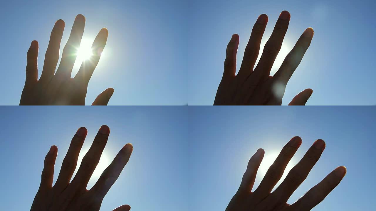 阳光穿过手指遮挡手部透过手指