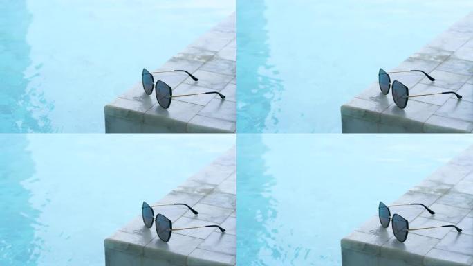 游泳池边的太阳镜太阳眼镜遗留在泳池边三亚