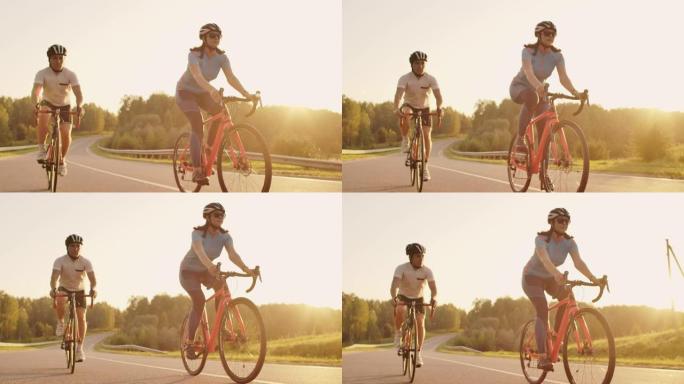 Steadicam拍摄了两个健康的mem和女人在日落时用自行车公路自行车快速兜售的照片。