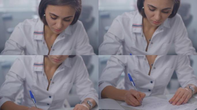 一位女医生坐在桌子旁，用笔写字，在玻璃墙后面向病人写处方。用笔写字特写