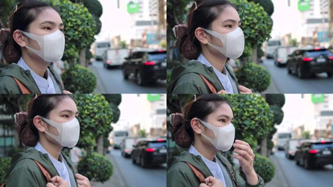 4k亚洲女性戴着鼻罩，防止空气中PM 2.5灰尘。