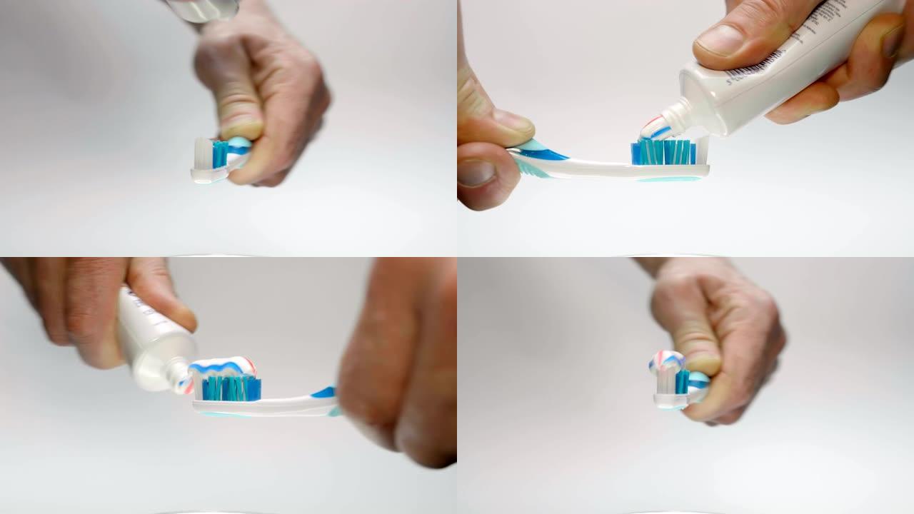 一名男子将牙膏从管子上挤在白色背上的蓝色牙刷上