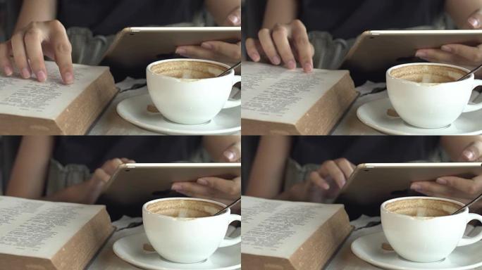 咖啡馆里有数字平板电脑和阅读书的女人