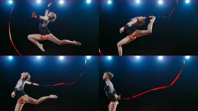 SLO MO SPEED RAMP LD艺术体操运动员在用红丝带绕一圈的同时进行雄鹿跳跃