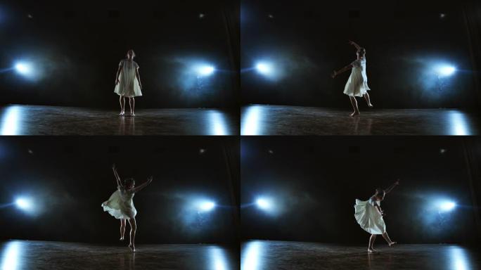 一个穿着白色连衣裙的女孩跳着现代芭蕾舞，在舞台上旋转，聚光灯下冒烟。