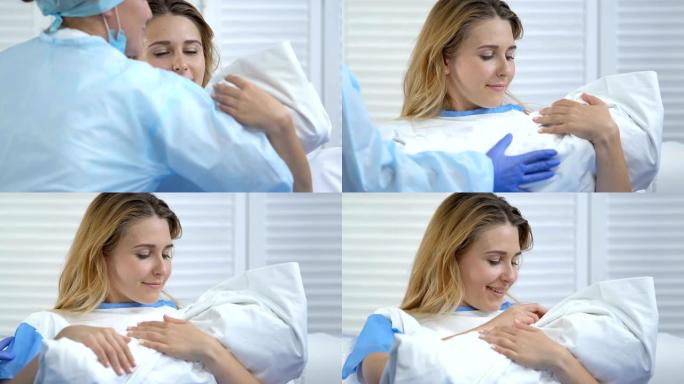 劳动护士将新生婴儿送给出汗的年轻母亲，产妇，分娩