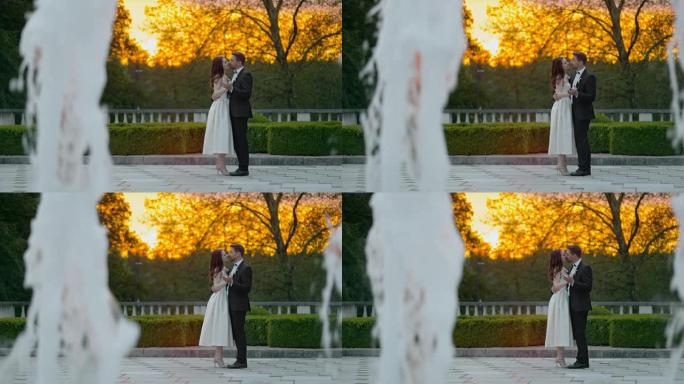 SLO MO新婚夫妇在露台上的喷泉旁跳舞