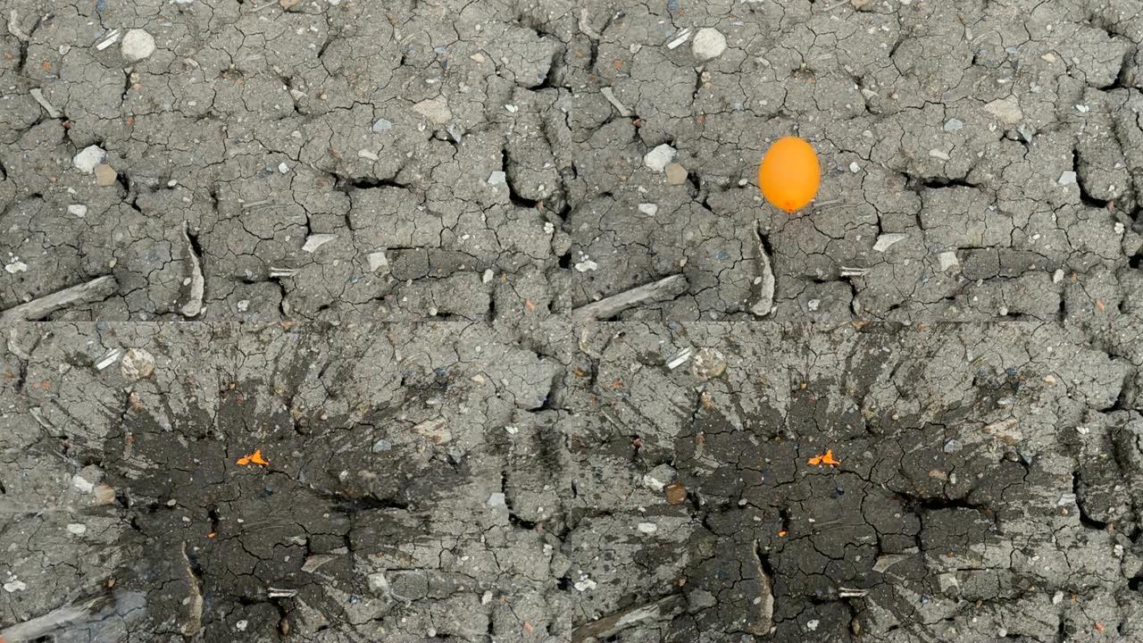 慢动作: 气球掉落在地面上后充满水飞溅