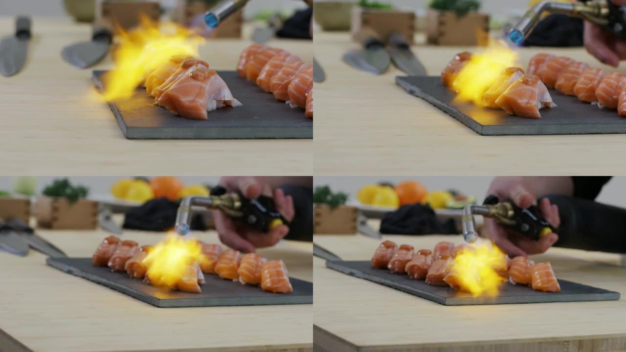 寿司厨师使用火炬将鲑鱼寿司