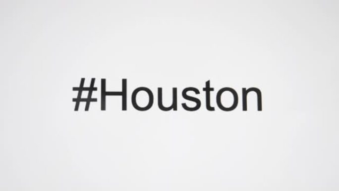 一个人在他们的电脑屏幕上输入 “# Houston”