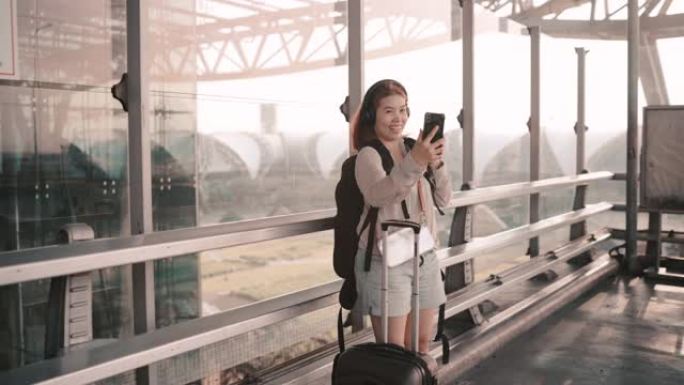 4k镜头女子站在机场外玩手机