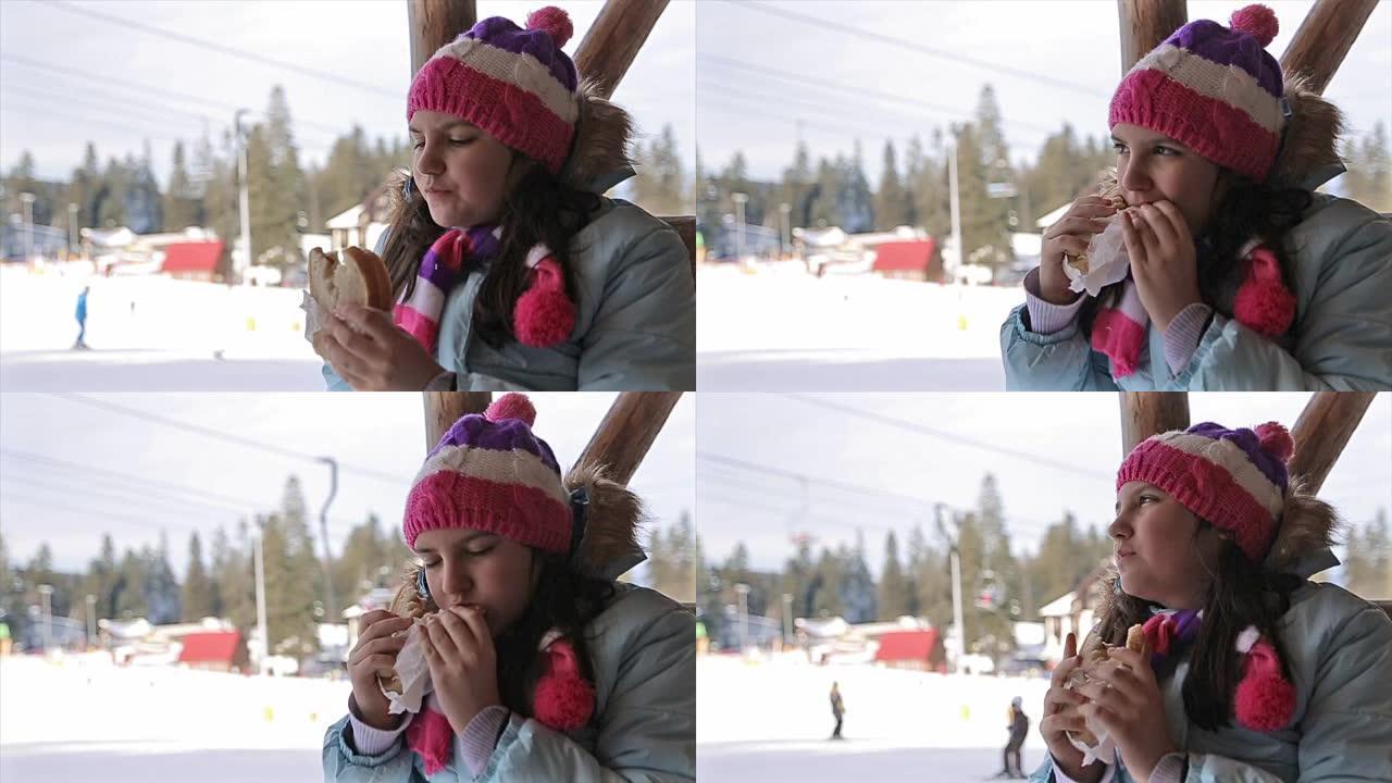 十几岁的女孩在滑雪休息时吃三明治
