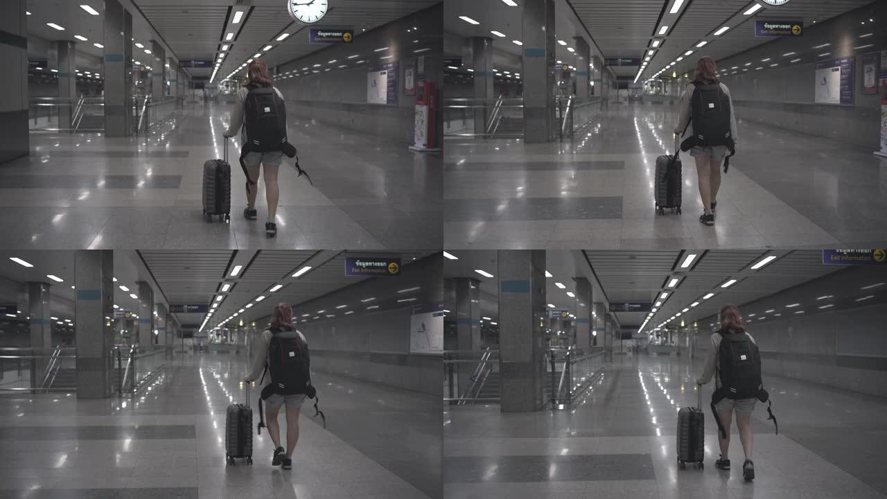 4k镜头女性旅行者在室内停车场将袋子从车里拿出来。