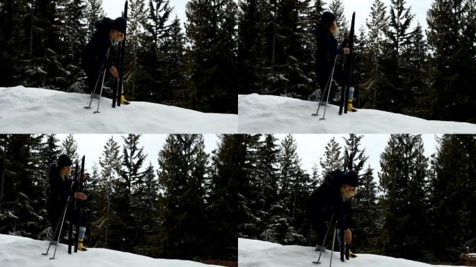 女越野滑雪者准备滑雪通过雪域森林