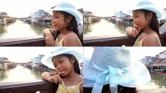 风景秀丽的水上市场戴帽子的年轻女孩。