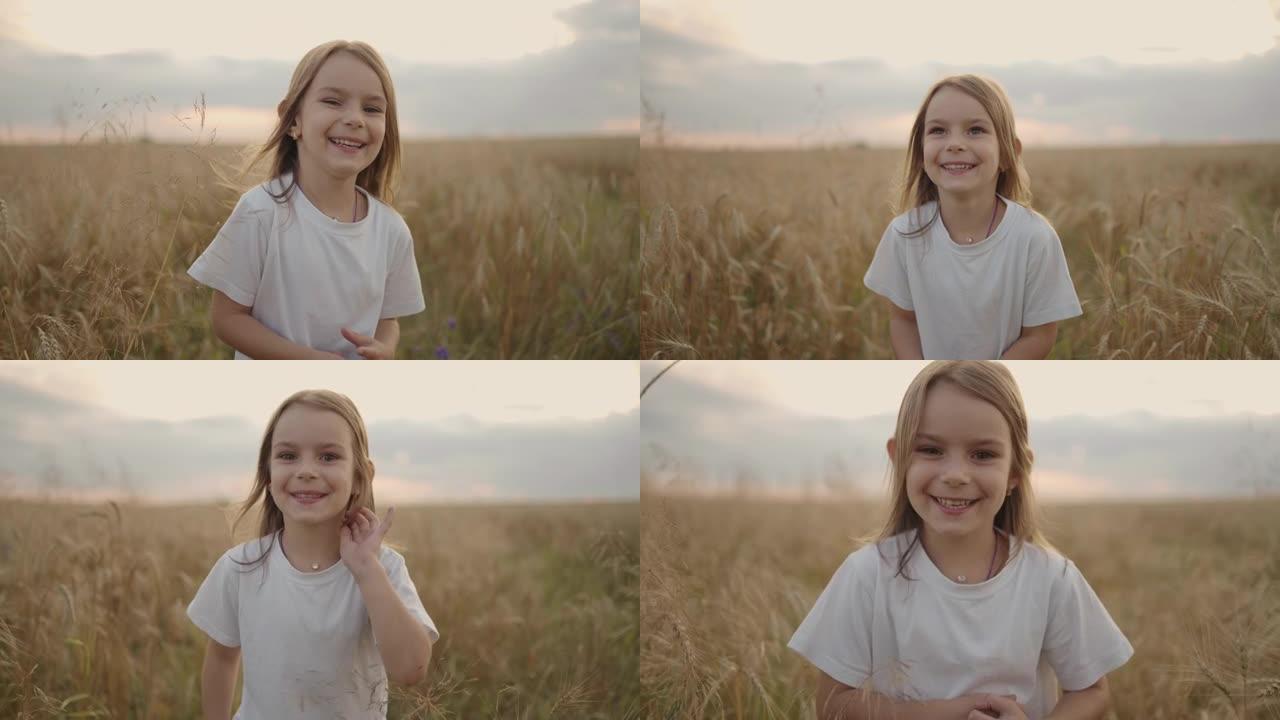 一个快乐微笑的小女孩看着镜头慢镜头跑在麦田里，夕阳西下