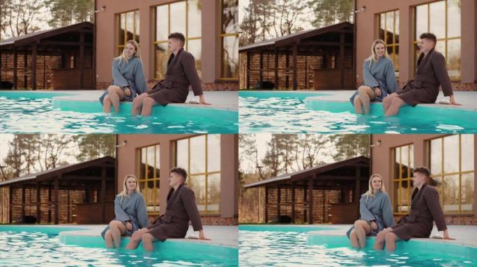男人和女人在生态自然场所的现代娱乐场所的开放式游泳池中放松