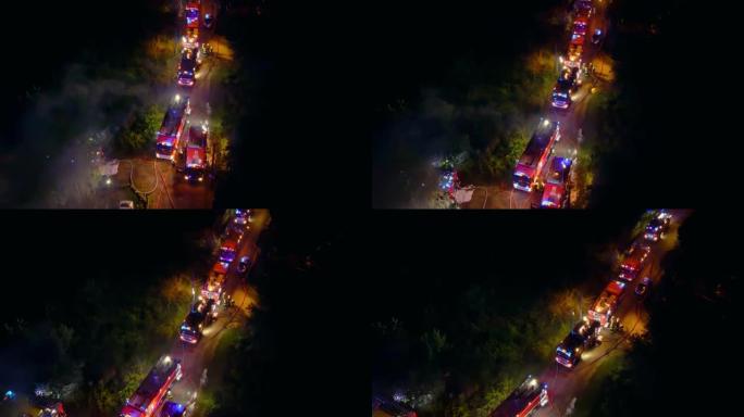 一群消防员夜间灭火的无人机飞行视点。英雄准备拯救危机中的人们