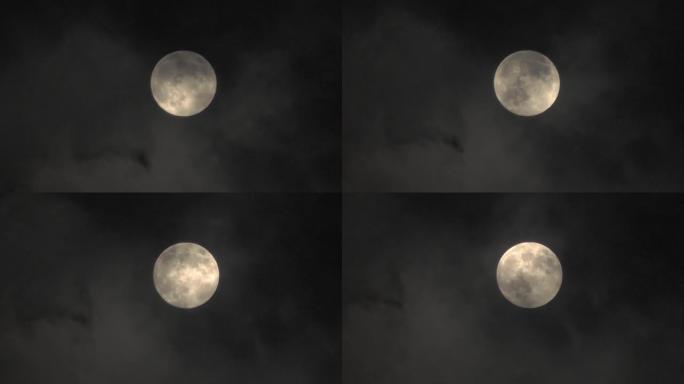 云中的月亮。夜空之谜。云在月亮前面飞快。远摄变焦