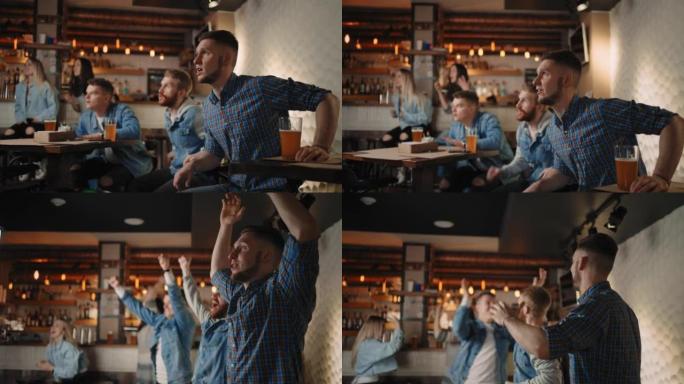 朋友们在酒吧里一起情绪激动地看着电视上的足球，庆祝他们的球队在进球后的胜利。看篮球，曲棍球。得分的冰