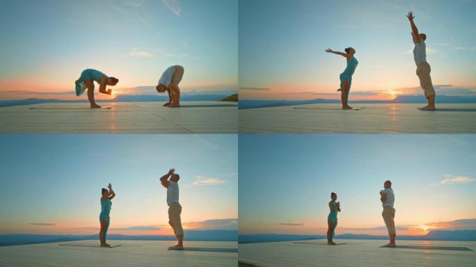 日落时在山上一起做瑜伽的CS男人和女人