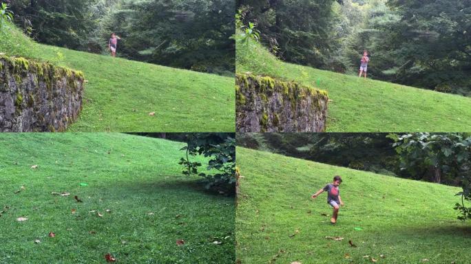 一个七岁的白人男孩用正手滚轴击球扔了一个圆盘 (飞盘)，它从石墙上弹起，落在下面被茂密的蔬菜包围的草