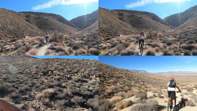 一名男子山地自行车手沿着狭窄的沙漠轨道行驶