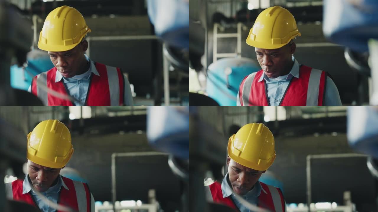 自信的非洲人在工厂工作。