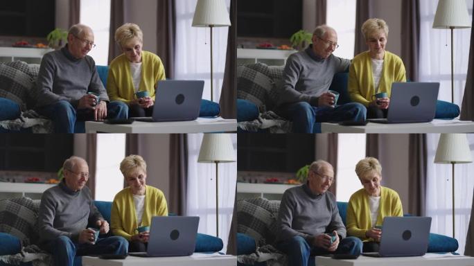 退休人员正在通过互联网与朋友和家人交流，使用带视频通话的笔记本电脑，坐在公寓里