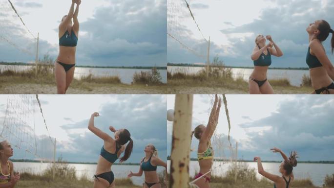 夏天，女人们在河边的公开球场上打沙滩排球，传球和进攻