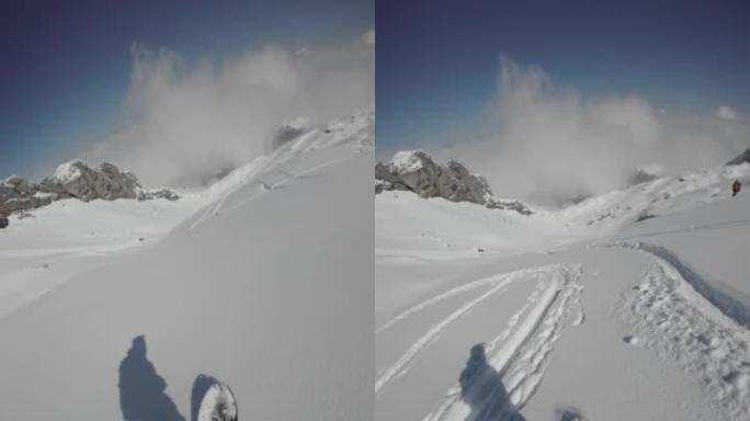 滑雪者下降新鲜的粉末雪山，可以欣赏下面阿尔卑斯山的景色