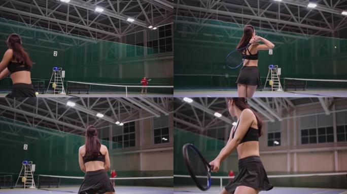 男人和女人在室内球场上一起打网球，年轻的女运动员用网球拍击球，全长慢动作射击