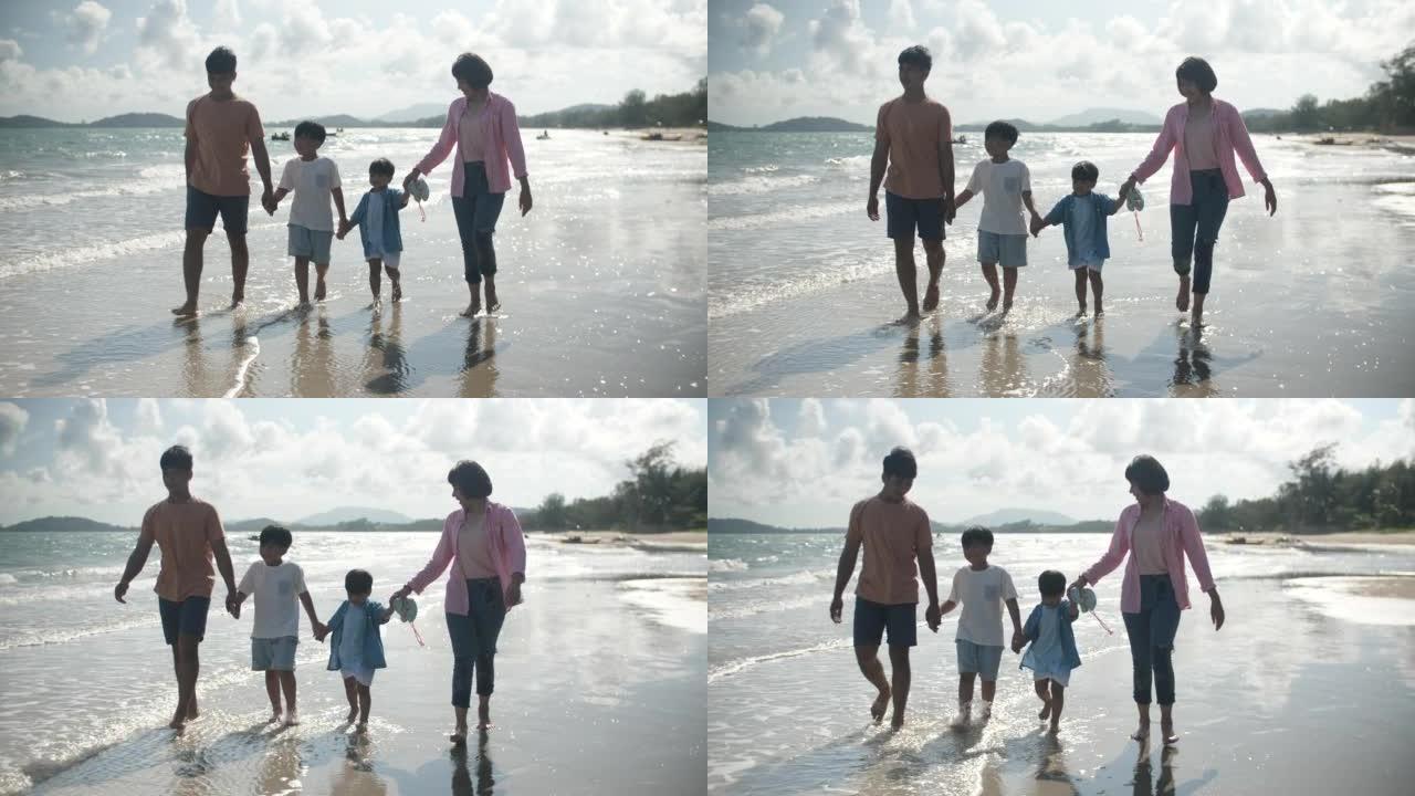 亚洲家庭带着幸福的情感在沙滩上散步