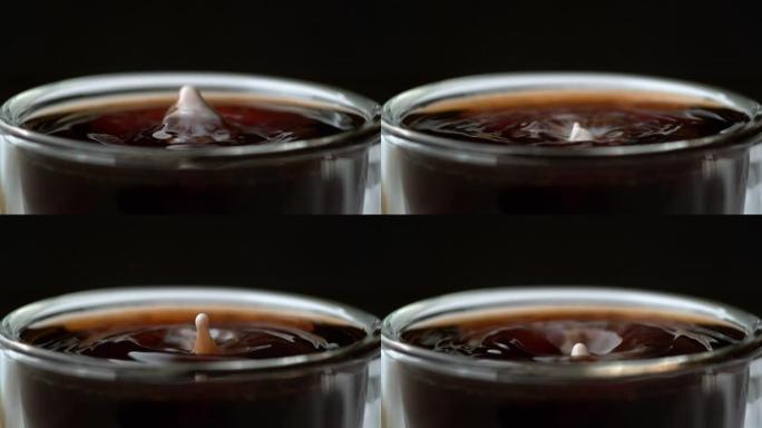 一滴奶精溅到一杯咖啡里。用幻影弹性4k相机拍摄。