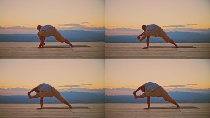 日出时在山顶上瑜伽姿势的SLO MO Man