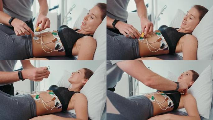 物理治疗师在运动诊所或康复中心对运动员腹部肌肉进行电疗法治疗。使用电流刺激肌肉恢复并减轻运动女性的疼