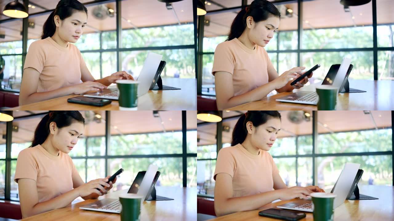 亚洲女性使用笔记本电脑，智能手机，平板电脑交易加密货币在咖啡馆。